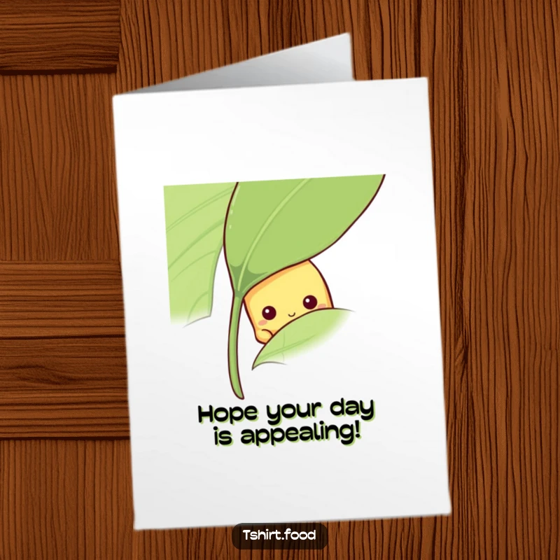 Funny Free Printable Birthday Card showing a shy banana peeking cautiously from behind a large green leaf, offering a sweet hello.