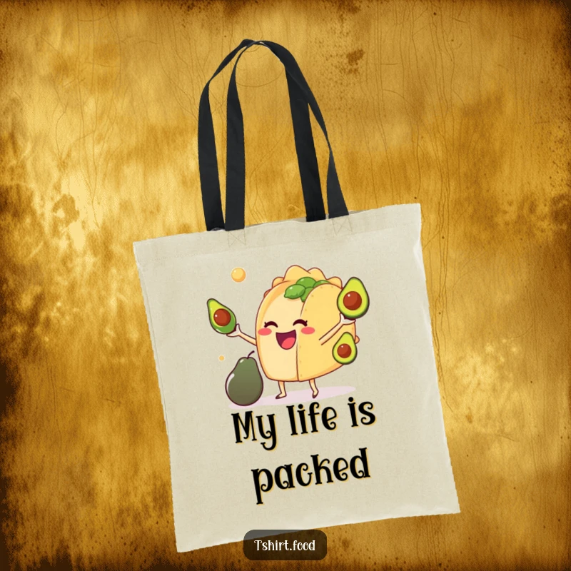 Funny tote bag with a delighted anthropomorphic taco juggling miniature avocados, ideal for shopping and as a humorous present.